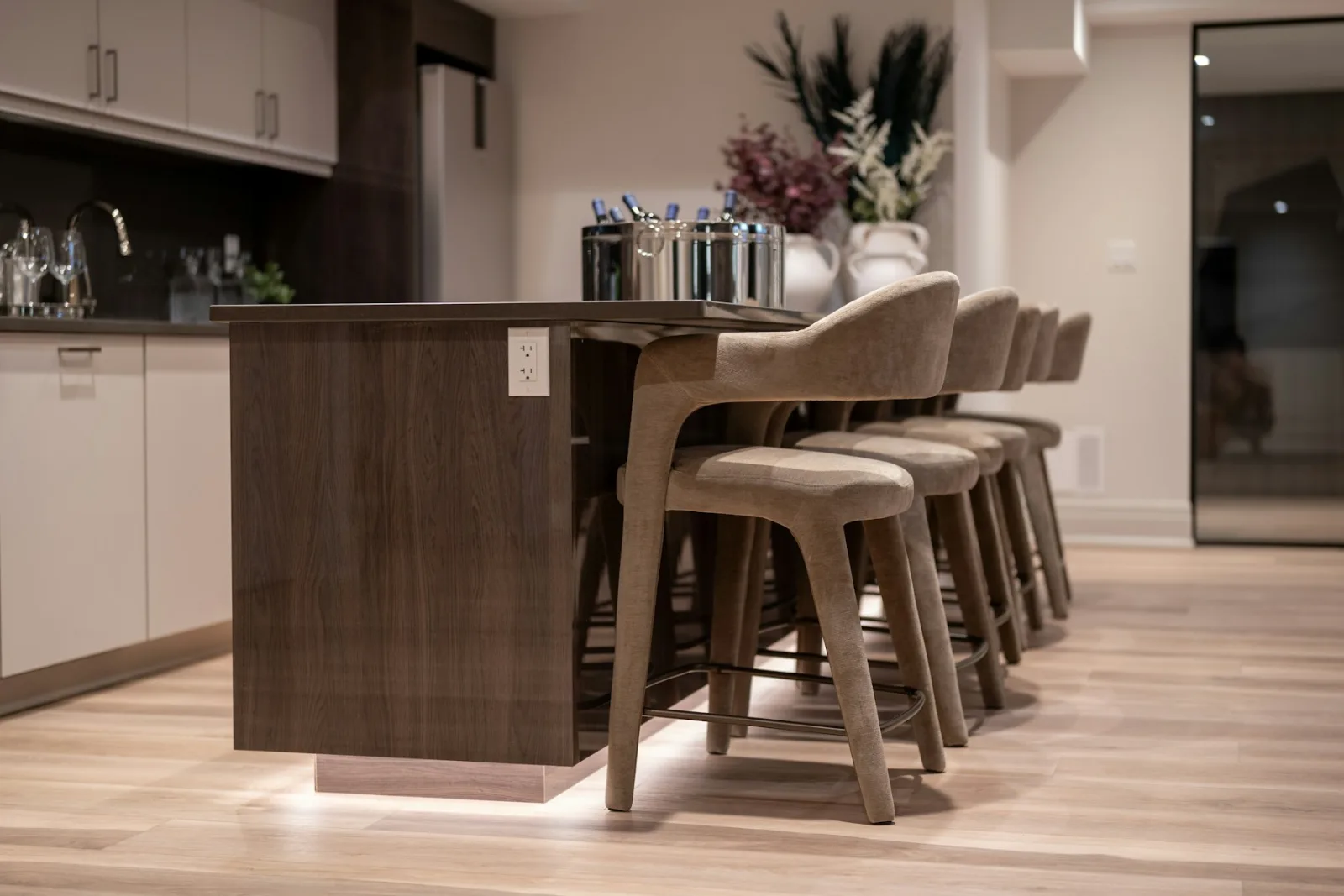 Tabourets de bar à assise rembourrée alignés sous un plan de cuisine